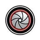 A circular logo with a red and black circle in the center.