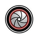 A circular logo with a red and black circle in the center.